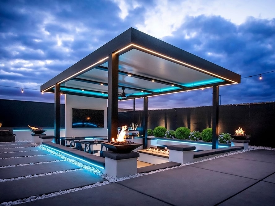 Freestanding Outdoor Elements Serenity louvered roof at dusk with LED strip lighting and fire bowls